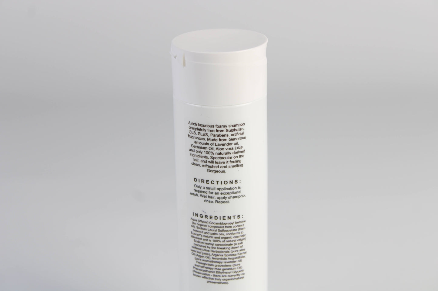 A photo of the back of Black & White's Natural Shampoo against a white background.