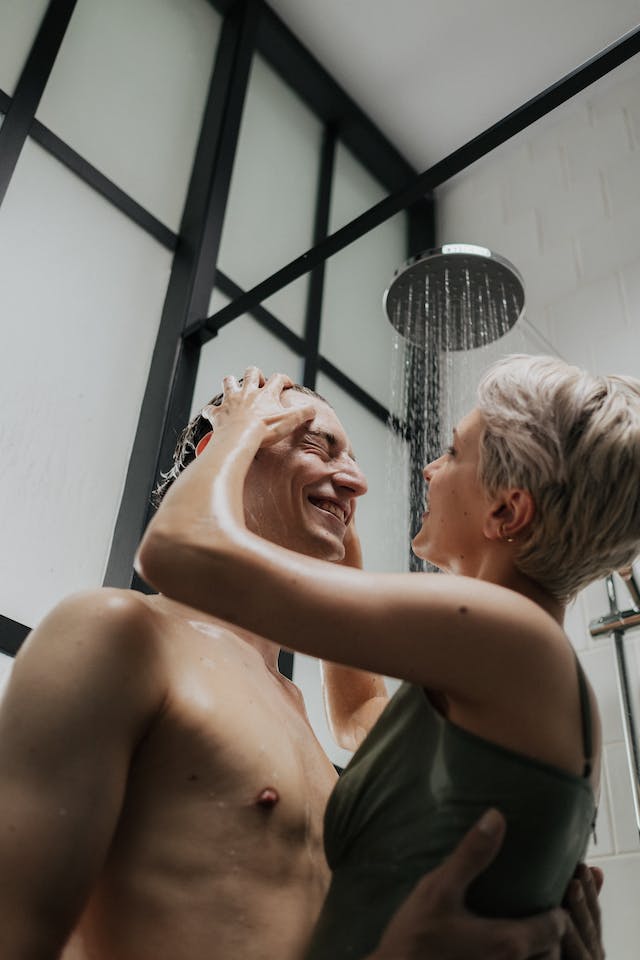 A female washing a males hair with our Anti-Hair Loss Shampoo.