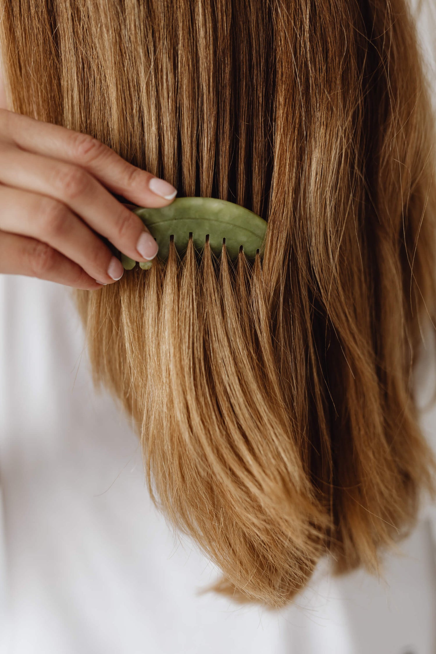 A female combing her hair.