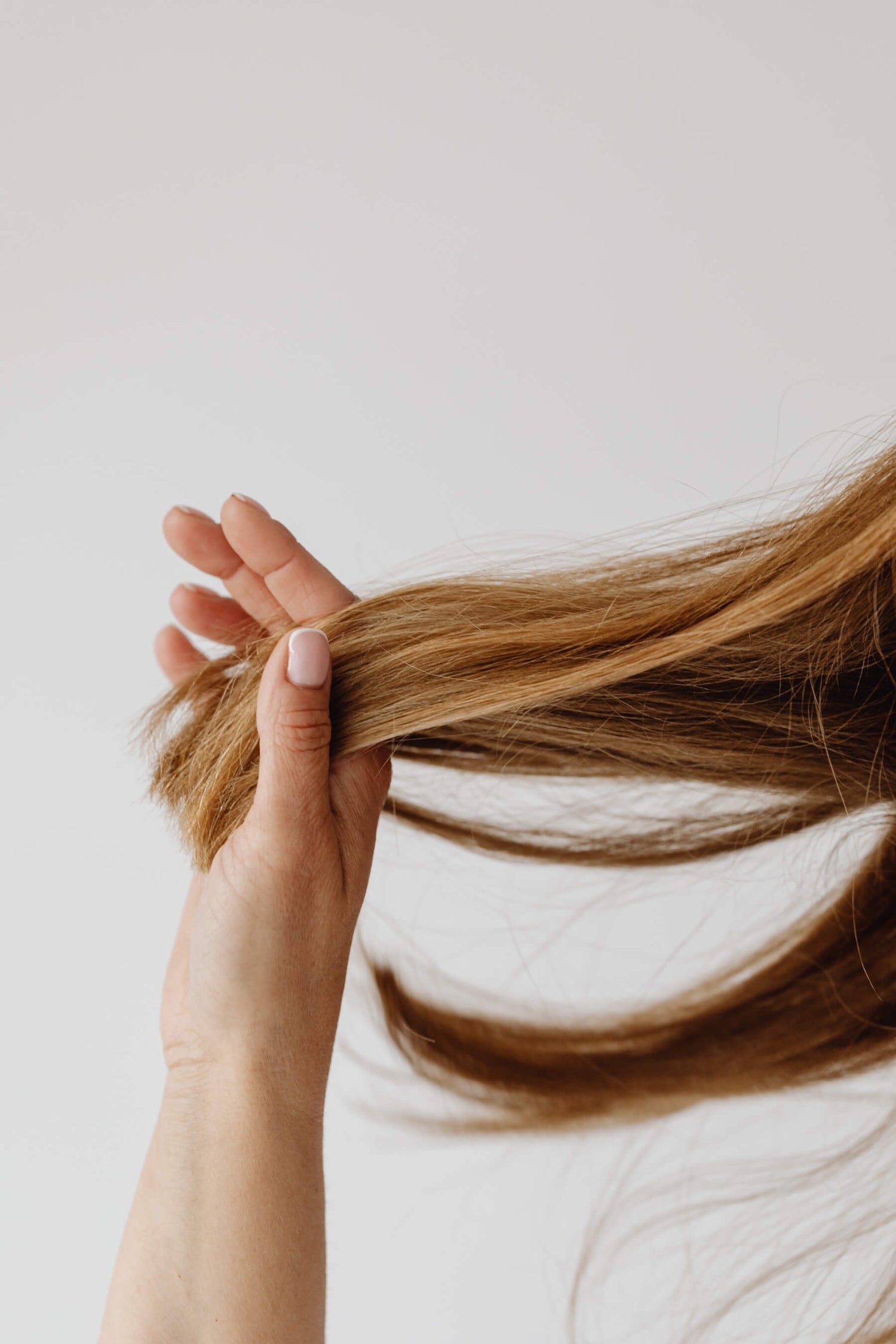 A woman playing with her soft hair.